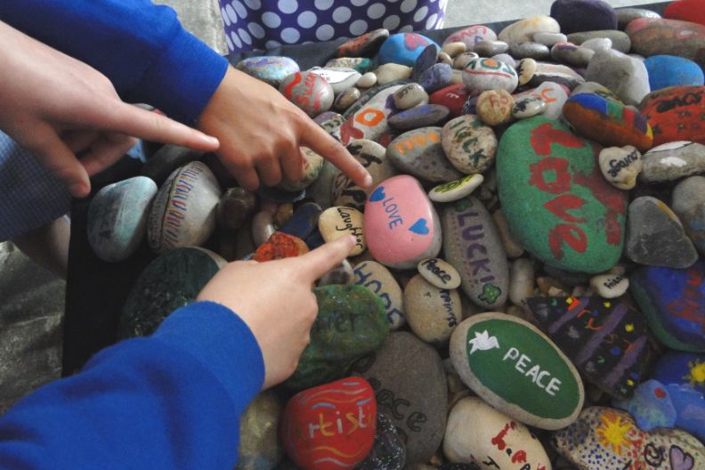 child pointing at stones